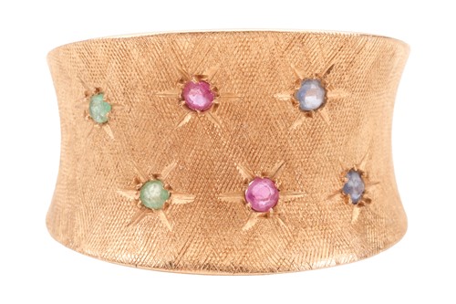 Lot 69 - A gem-set concave dress ring, star-set with...