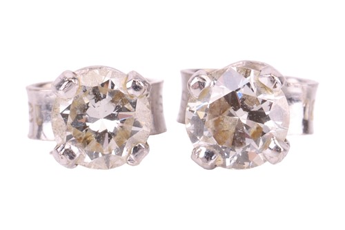 Lot 60 - A pair of diamond solitaire stud earrings,...