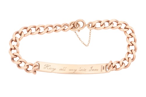 Lot 30 - An engraved ID bracelet in 9ct yellow gold,...