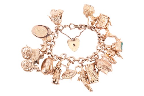 Lot 77 - A 9ct gold charm bracelet; the oval link...