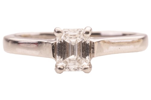 Lot 10 - An emerald-cut diamond solitaire ring in...