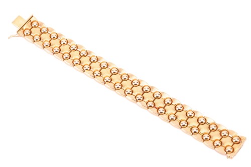 Lot 15 - A wide fancy link bracelet, comprising a...