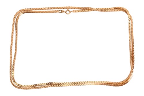 Lot 73 - A long foxtail link chain, terminated with a...