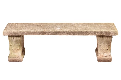 Lot 112 - An established cast-stone garden firm bench,...