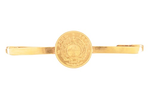 Lot 62 - A half pond coin collar pin, centred with an...