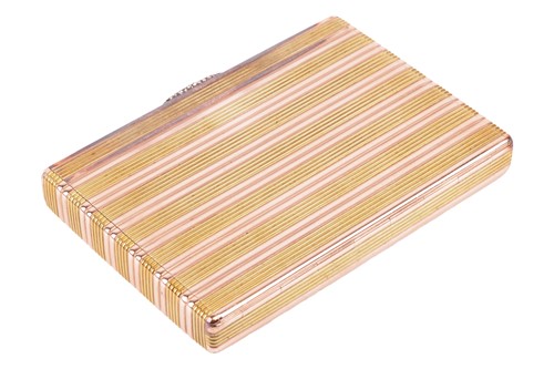 Lot 190 - A cigarette case by Fabergé, reeded case of bi-...