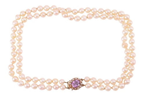 Lot 106 - A double-strand cultured pearl necklace; the...