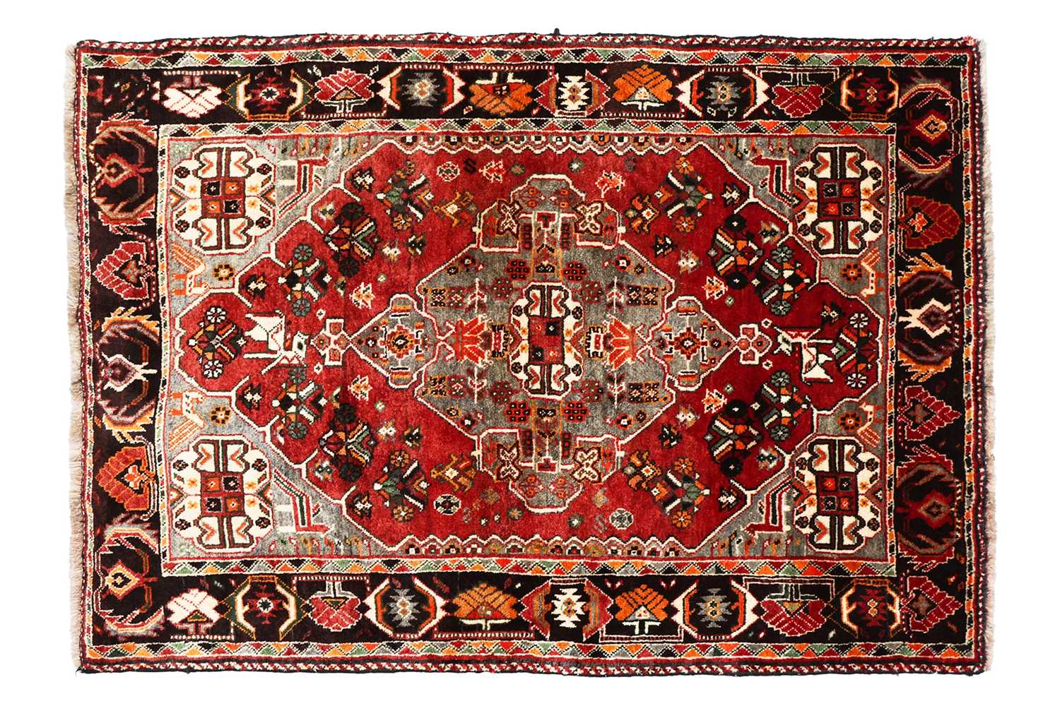 Lot 144 - A plum-coloured ground Baktiari rug with a...