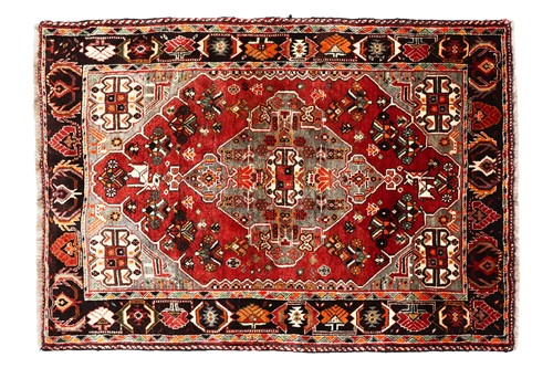 Lot 144 - A plum-coloured ground Baktiari rug with a...