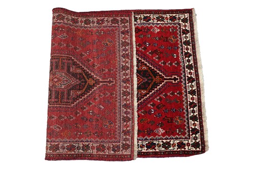 Lot 145 - A red ground Qashqai rug with two diamond...