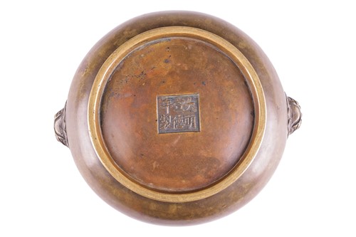Lot 63 - A Chinese Ming Dynasty style patinated bronze...