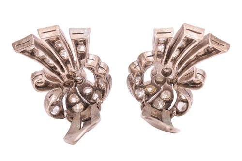 Lot 73 - A pair of diamond-set ear clips, of scrolling...