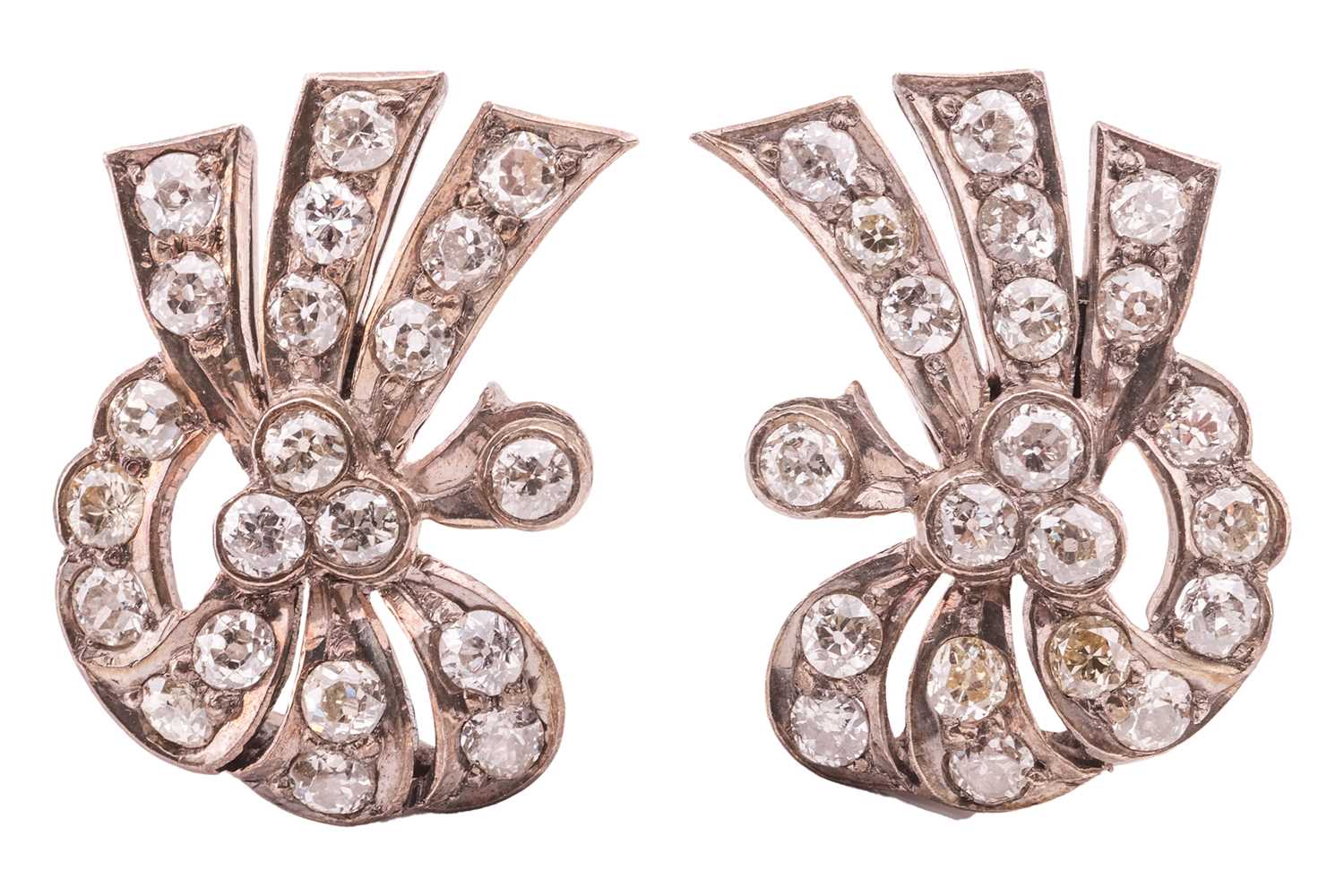 Lot 73 - A pair of diamond-set ear clips, of scrolling...