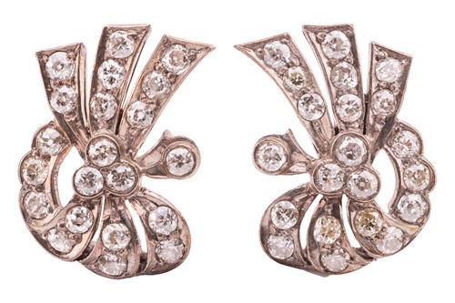 Lot 73 - A pair of diamond-set ear clips, of scrolling...