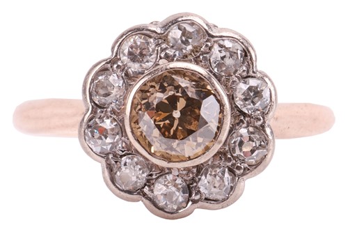Lot 115 - A diamond daisy head cluster ring, featuring a...