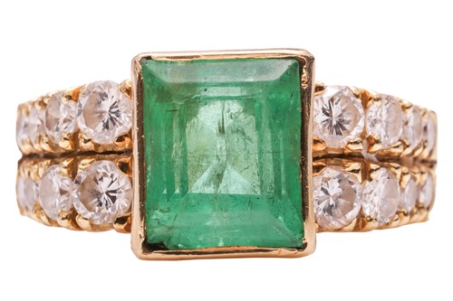 Lot 258 - An emerald and diamond dress ring, featuring a...