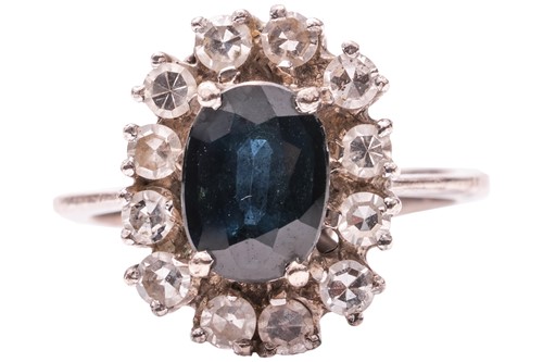 Lot 251 - A sapphire and diamond cluster ring, claw-set...