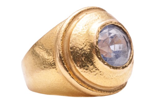 Lot 125 - A sapphire dress ring, centred with an...