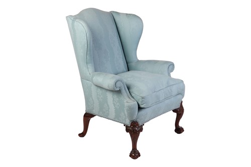 Lot 96 - A well-drawn George II-style mahogany wingback...