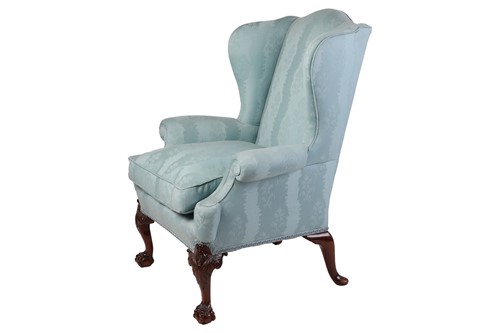 Lot 96 - A well-drawn George II-style mahogany wingback...