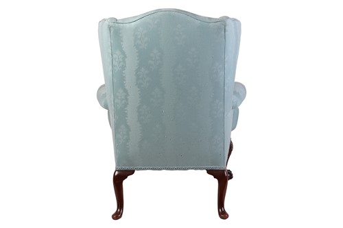 Lot 96 - A well-drawn George II-style mahogany wingback...