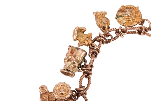 Lot 16 - A 9ct gold charm bracelet, comprising a cable...
