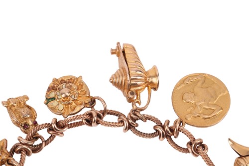 Lot 16 - A 9ct gold charm bracelet, comprising a cable...