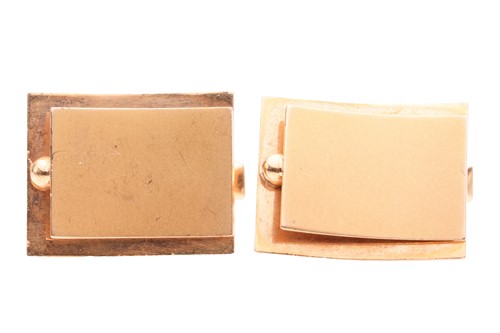 Lot 98 - A pair of cufflinks of abstract design, curved...
