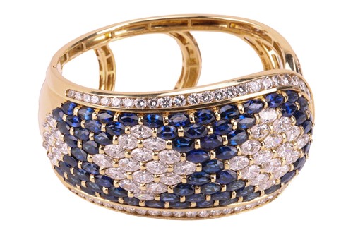 Lot 79 - A sapphire and diamond-hinged bangle the...