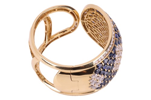 Lot 79 - A sapphire and diamond-hinged bangle the...