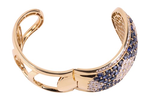 Lot 79 - A sapphire and diamond-hinged bangle the...