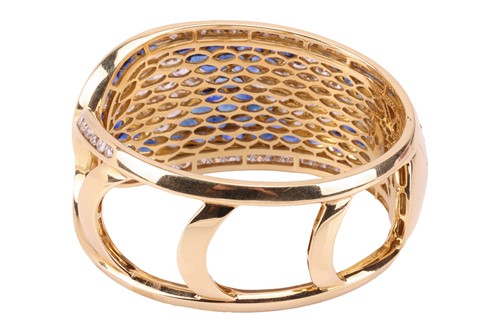 Lot 79 - A sapphire and diamond-hinged bangle the...
