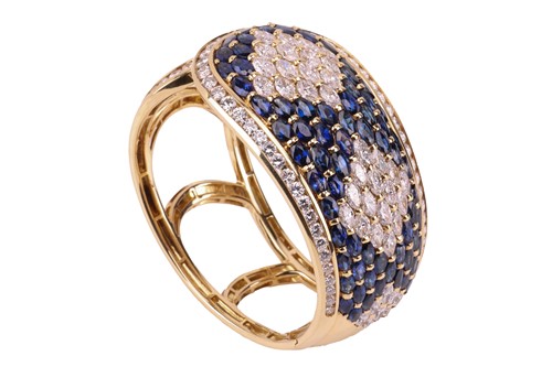Lot 79 - A sapphire and diamond-hinged bangle the...