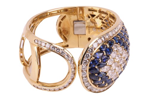 Lot 79 - A sapphire and diamond-hinged bangle the...