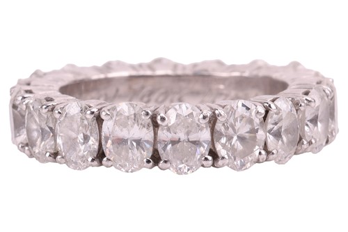 Lot 186 - An oval-cut diamond eternity ring, comprising...