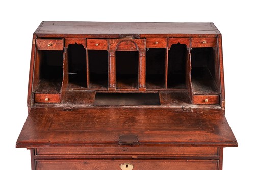 Lot 123 - A George I and later oak writing bureau, the...