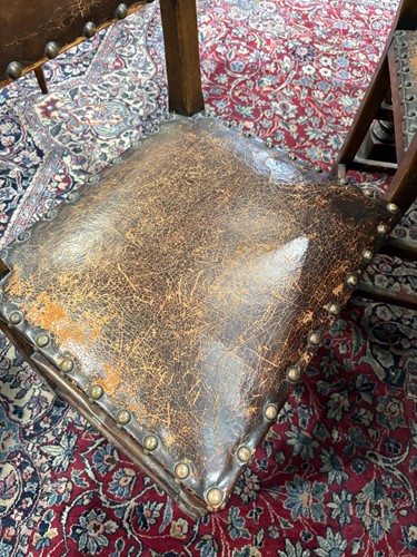 Lot 97 - A set of six Cromwellian-style oak and leather...
