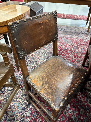 Lot 97 - A set of six Cromwellian-style oak and leather...