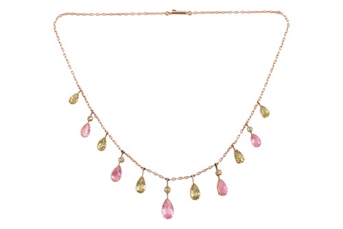 Lot 26 - An Edwardian fringe necklace set with peridot...