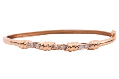 Lot 7 - A diamond set hinged bangle, comprising of a...