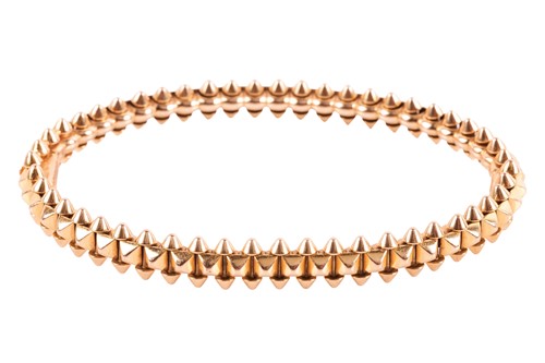 Lot 170 - Cartier - a Clash de Cartier hinged bangle,...