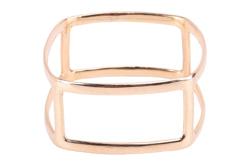 Lot 79 - An angular closed bangle of cut-out design,...