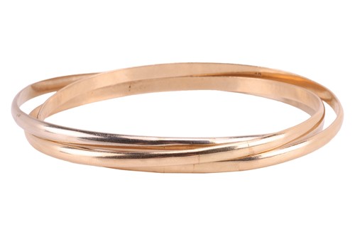 Lot 176 - A trilogy bangle, formed of three interlocking...