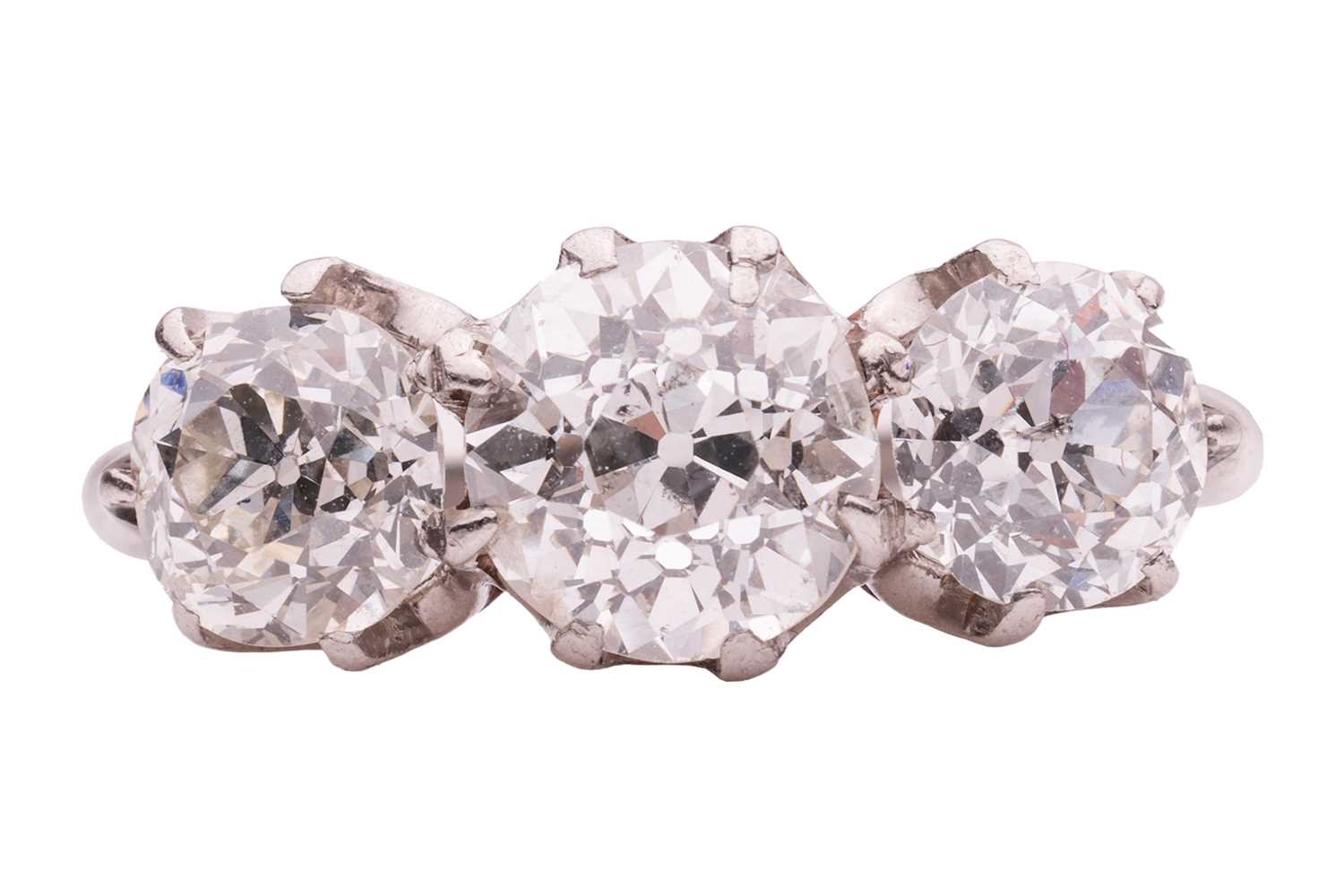 Lot 50 - An old-cut diamond trilogy ring, claw-set with...