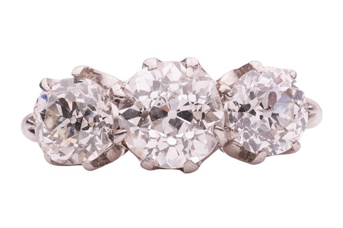 Lot 50 - An old-cut diamond trilogy ring, claw-set with...