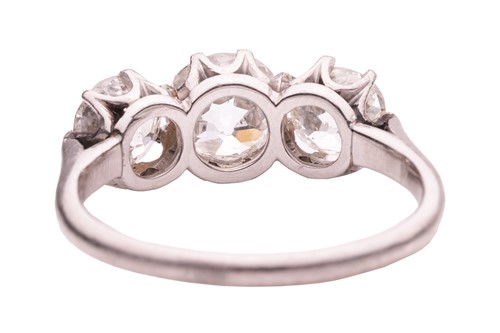 Lot 50 - An old-cut diamond trilogy ring, claw-set with...