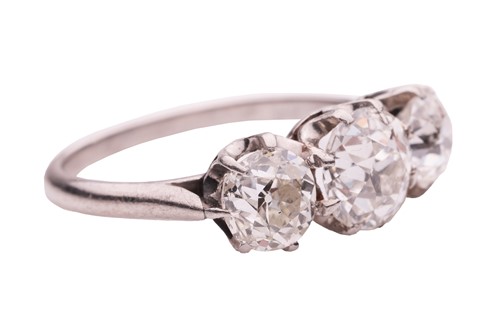 Lot 50 - An old-cut diamond trilogy ring, claw-set with...