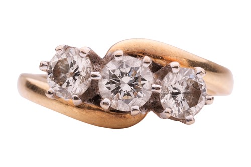 Lot 146 - A three-stone diamond crossover ring,...