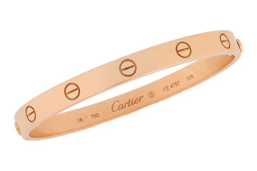 Lot 178 - Cartier - a 'LOVE' bangle in 18ct yellow gold,...
