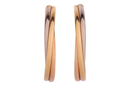 Lot 180 - Cartier - a pair of Trinity hoop earrings in...